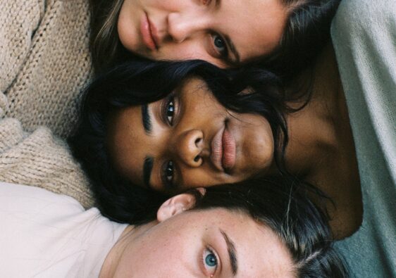 three women in assorted-color tops