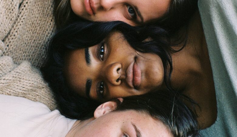 three women in assorted-color tops